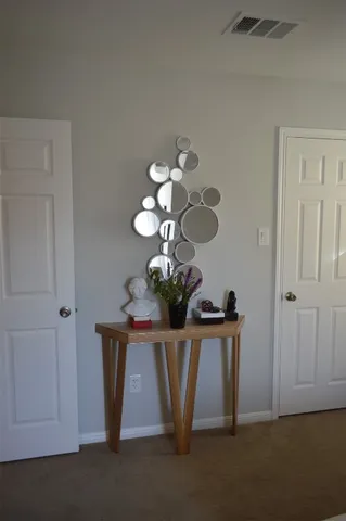 a bedroom with a bed a flat screen tv and a large window