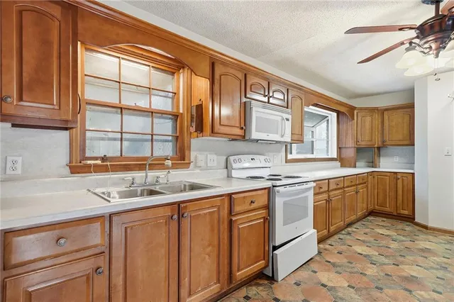 a kitchen with a sink stove and cabinets