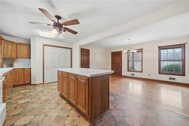 a view of a kitchen with cabinets and wooden floor