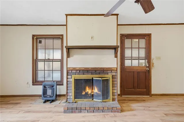 an empty room with fireplace and windows