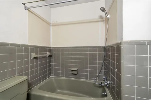 a bath tub sitting next to a blue sink