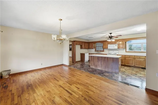 a view of a kitchen with a stove cabinets and wooden floor