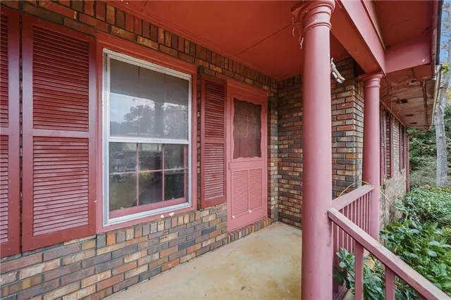 a view of a house with a window and wooden fence