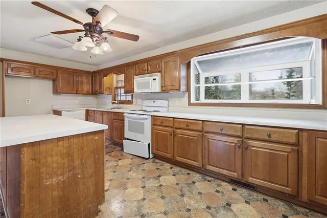 a kitchen with a stove a sink and a refrigerator