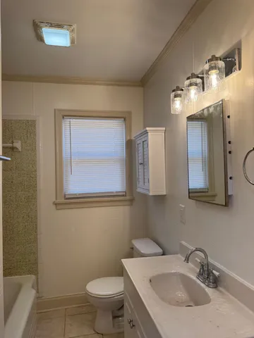 a bathroom with a sink toilet and mirror
