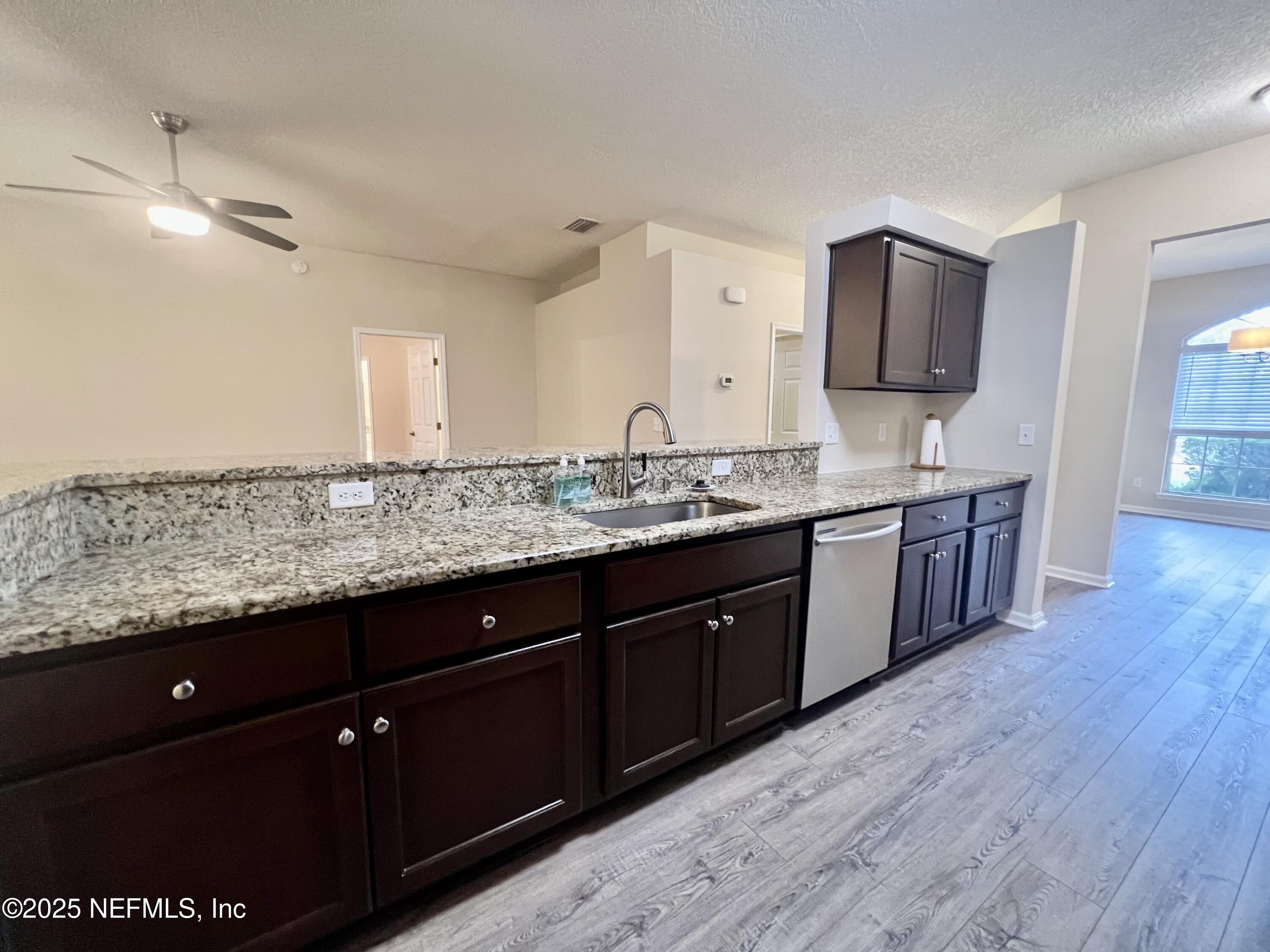 1455 Silver Bell Lane Fleming Island, FL 32003 - Photo 11 of 37 a spacious bathroom with a granite countertop sink and a mirror