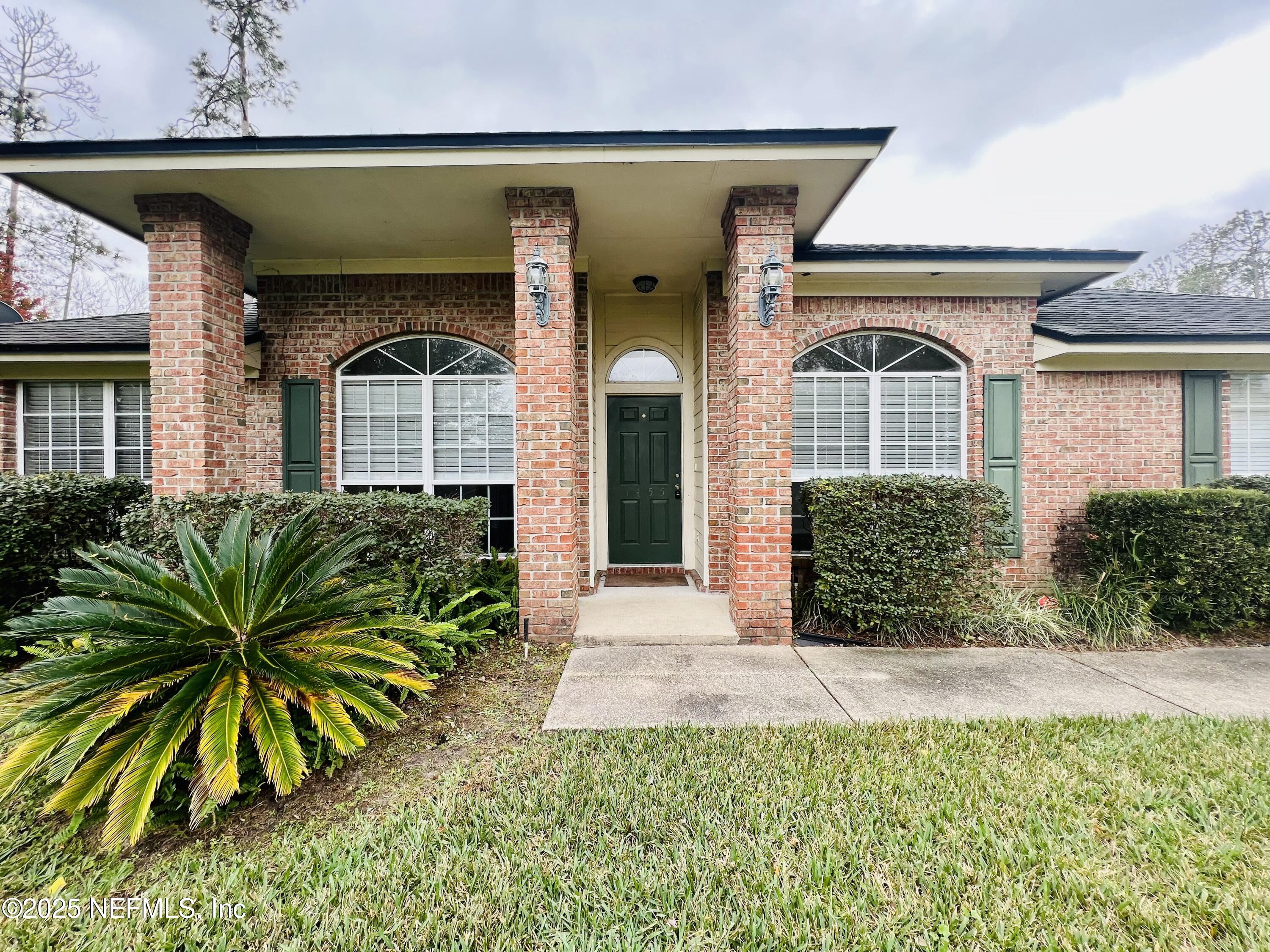 1455 Silver Bell Lane Fleming Island, FL 32003 - Photo 2 of 37 a front view of a house with a yard