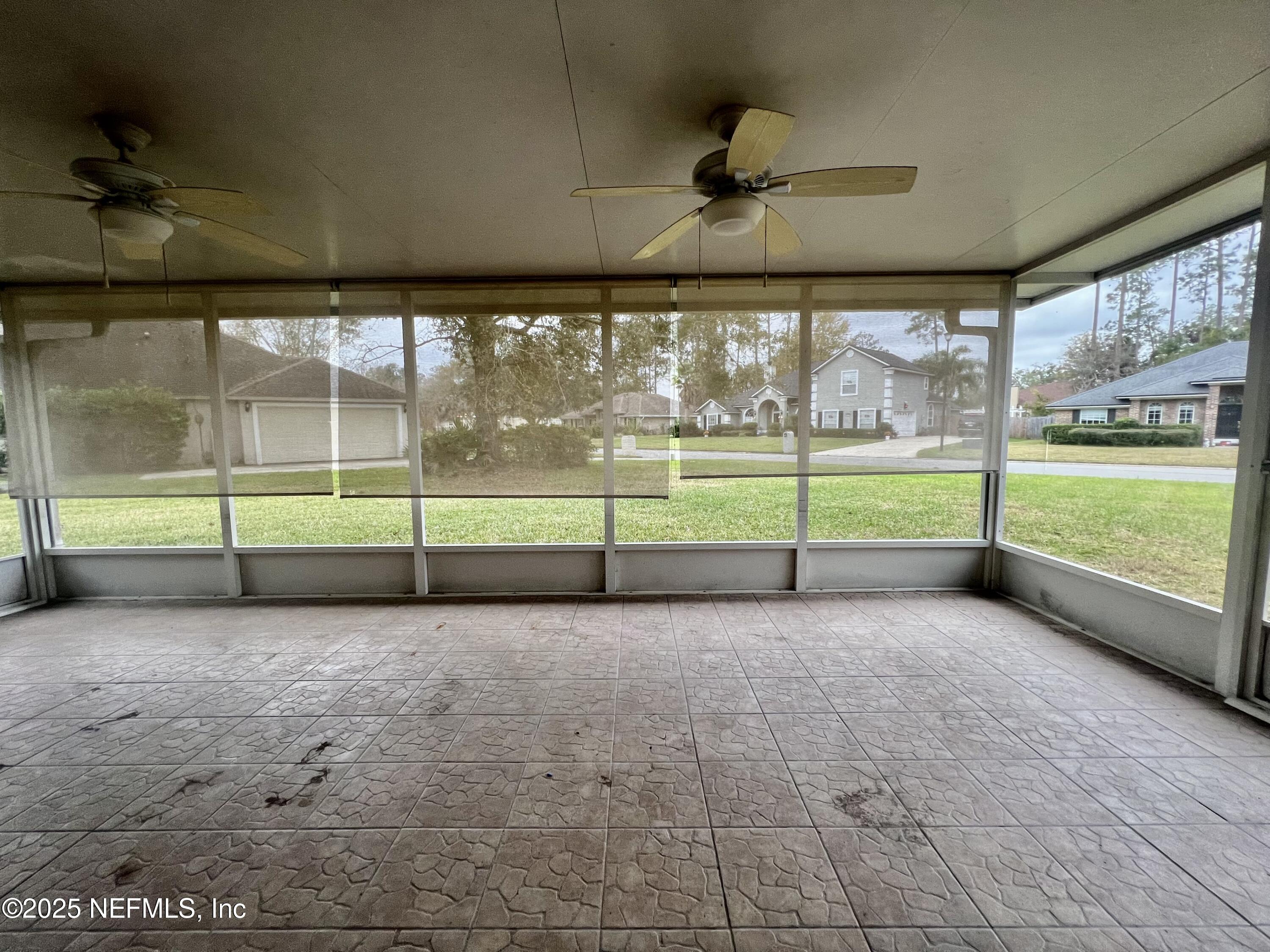 1455 Silver Bell Lane Fleming Island, FL 32003 - Photo 29 of 37 a view of a room with wooden floor and a floor to ceiling window