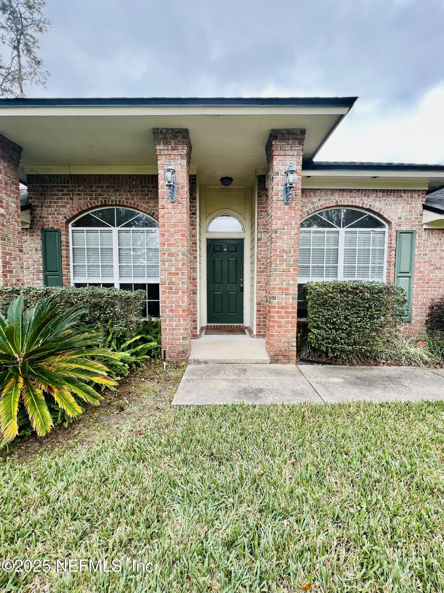 1455 Silver Bell Lane Fleming Island, FL 32003 - Photo 3 of 37 a front view of a house with a yard