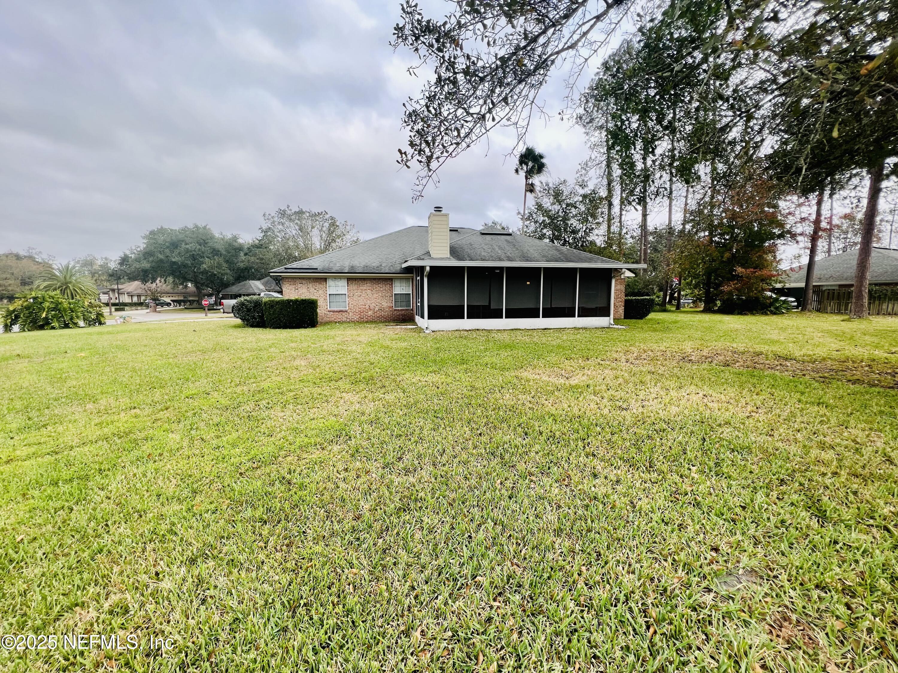 1455 Silver Bell Lane Fleming Island, FL 32003 - Photo 33 of 37 a front view of house with yard and trees