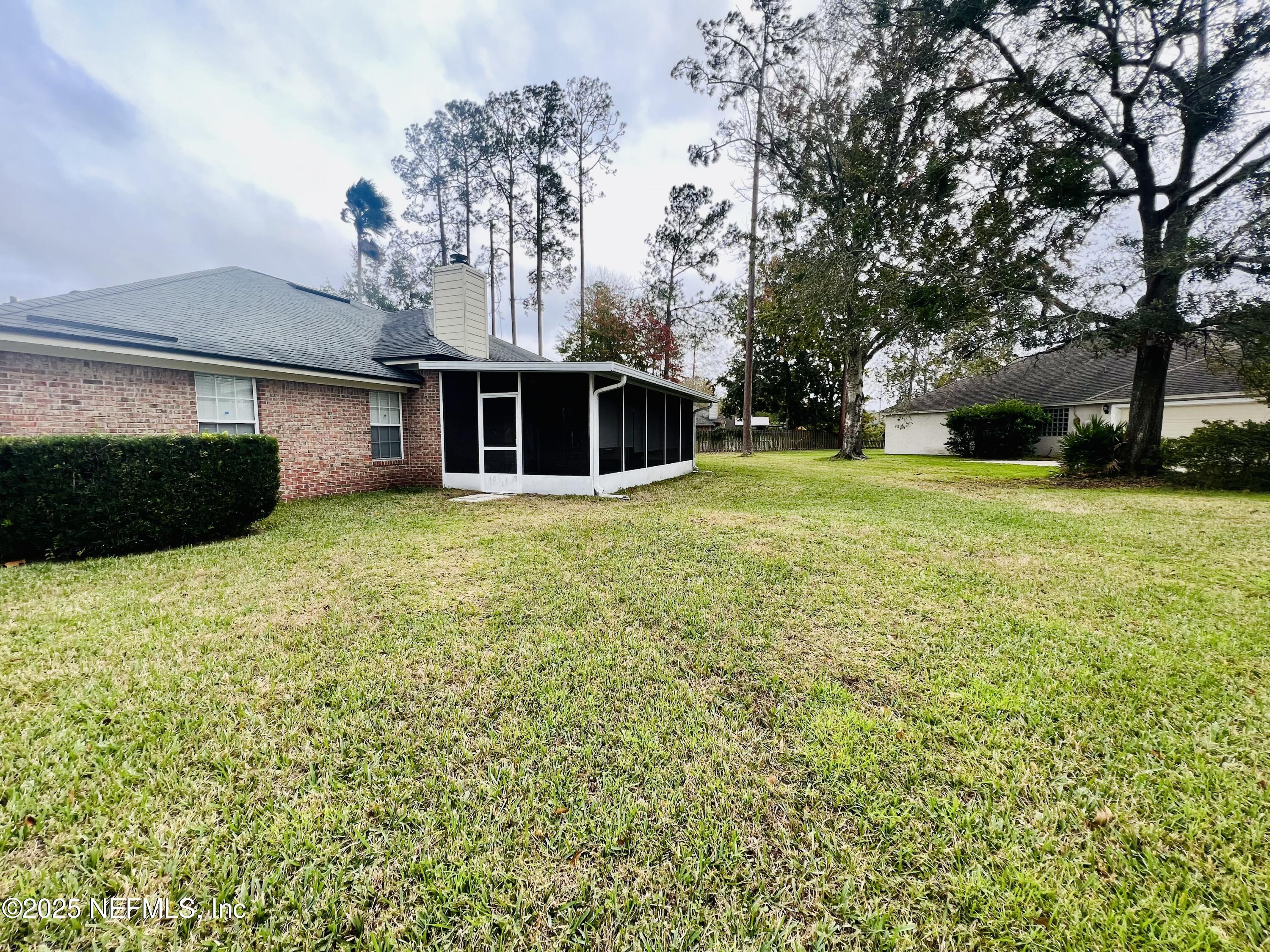 1455 Silver Bell Lane Fleming Island, FL 32003 - Photo 37 of 37 a front view of a house with a yard and garage