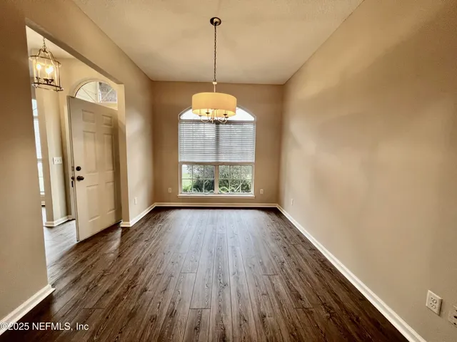 a large kitchen with stainless steel appliances granite countertop a sink stove and refrigerator