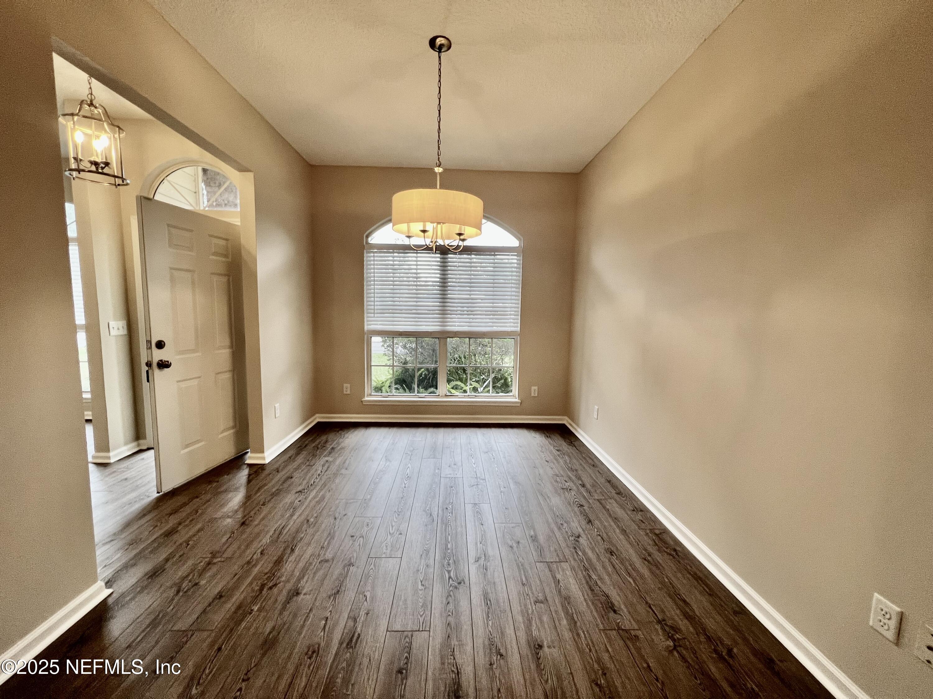 1455 Silver Bell Lane Fleming Island, FL 32003 - Photo 7 of 37 a view of a room with wooden floor fan and window