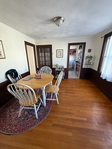 a living room with furniture rug and wooden floor