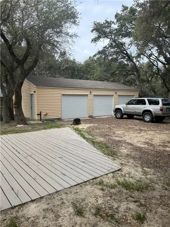 a view of backyard with parked area