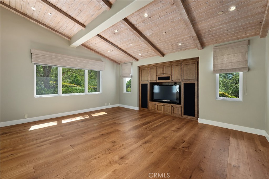 6533 Lago Lindo Rancho Santa Fe, CA 92067 - Photo 35 of 57 an empty room with wooden floor and windows