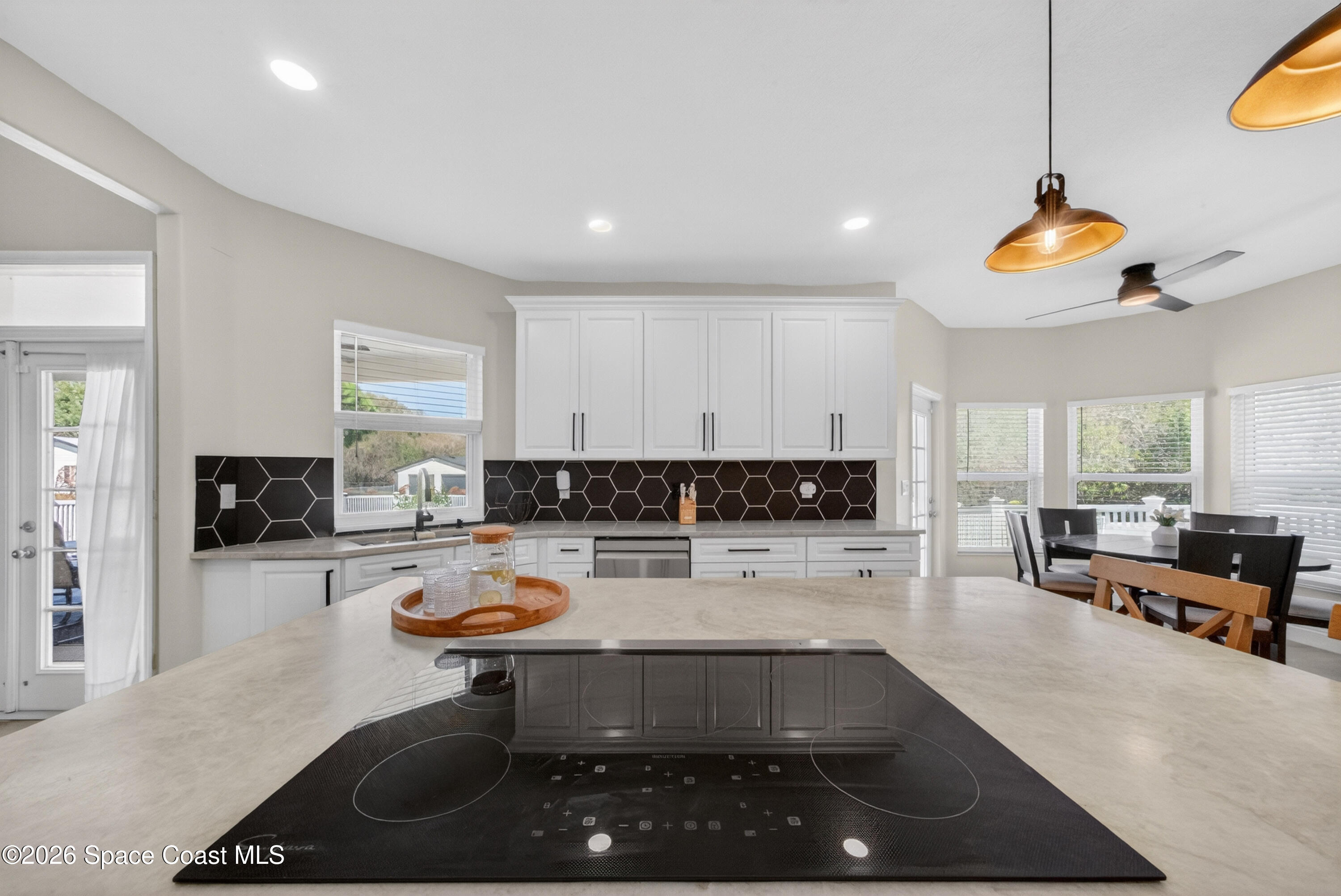 210 Grant Road Merritt Island, FL 32953 - Photo 19 of 64 a kitchen with a sink a stove and cabinets