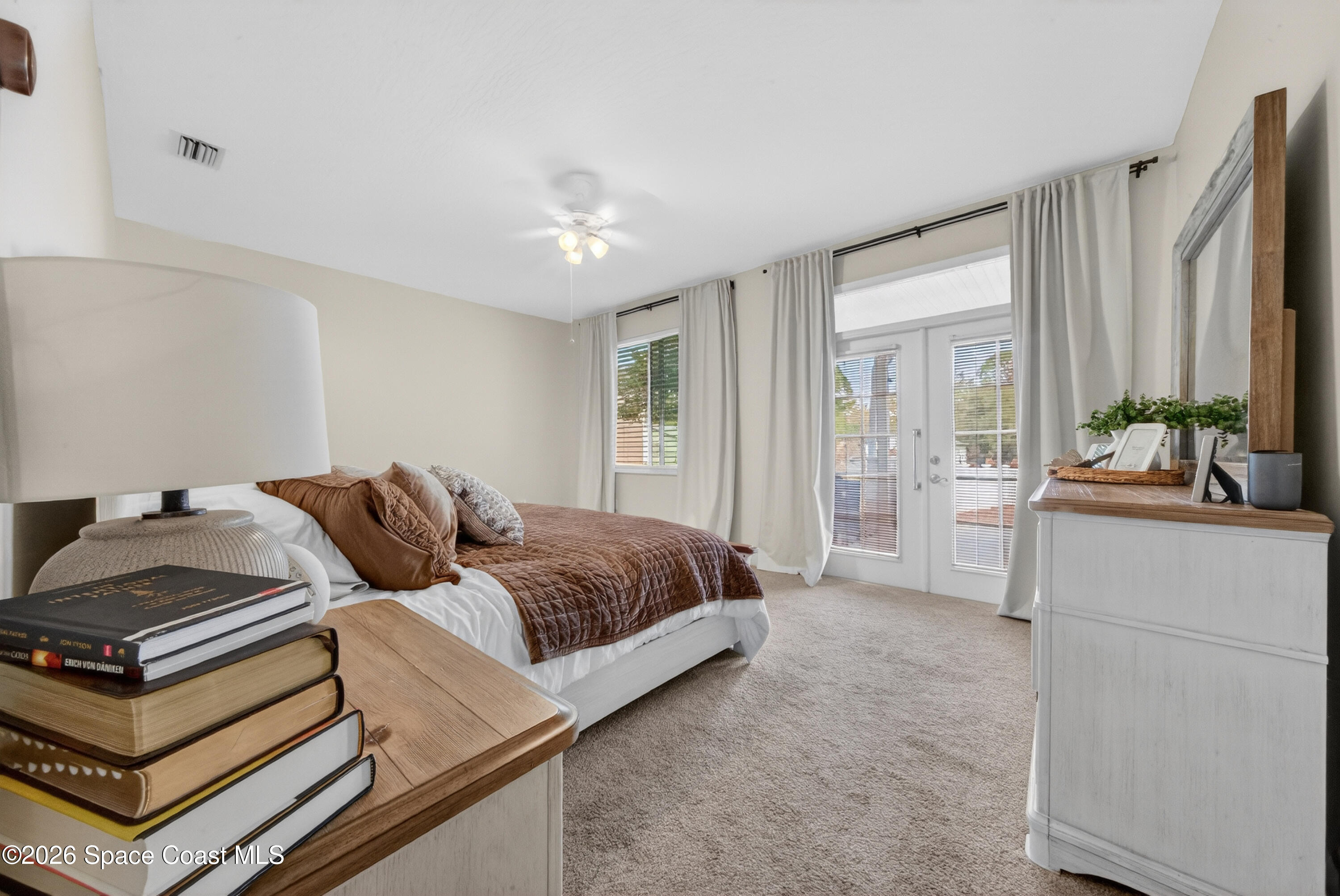 210 Grant Road Merritt Island, FL 32953 - Photo 24 of 64 a bedroom with a bed and a dresser