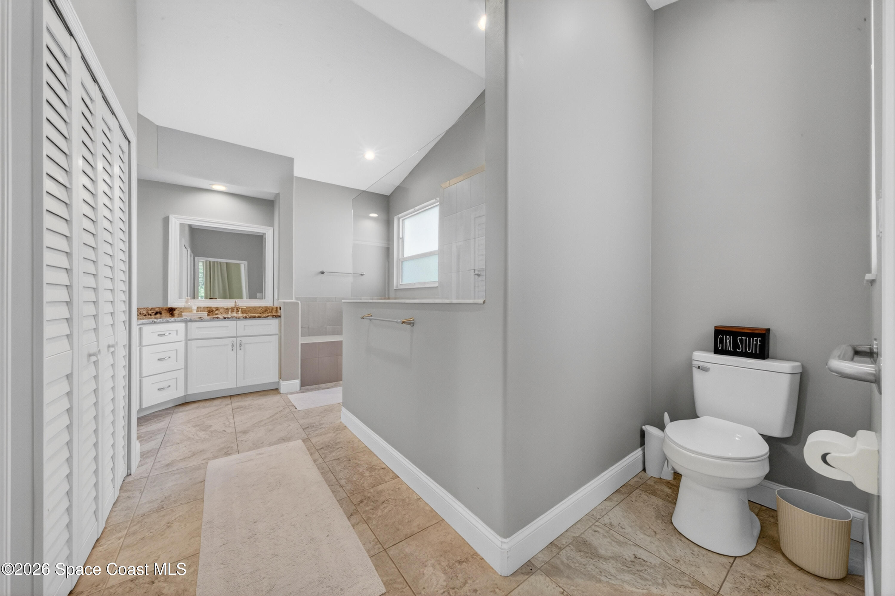 210 Grant Road Merritt Island, FL 32953 - Photo 29 of 64 a bathroom with a sink toilet vanity and tub