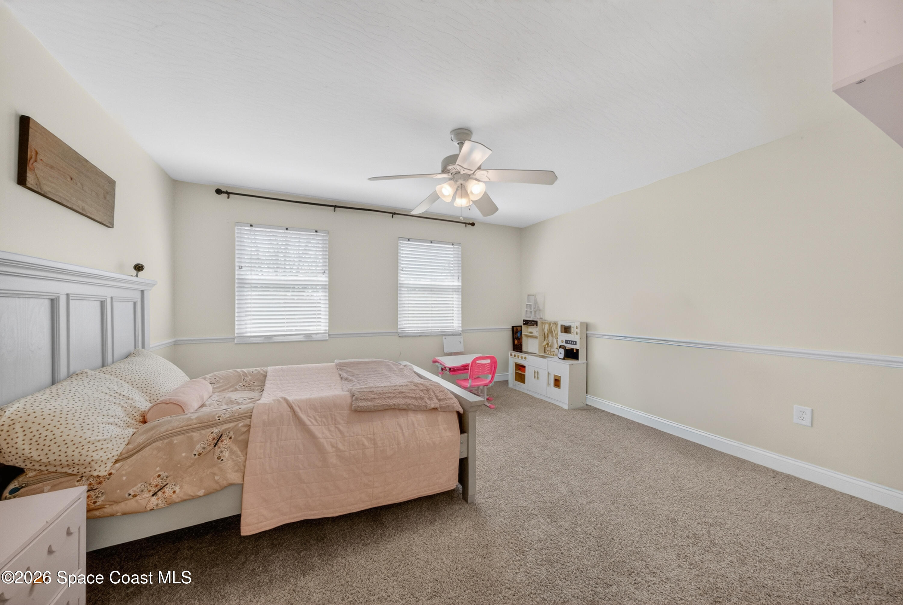 210 Grant Road Merritt Island, FL 32953 - Photo 37 of 64 a bedroom with a bed and a chandelier