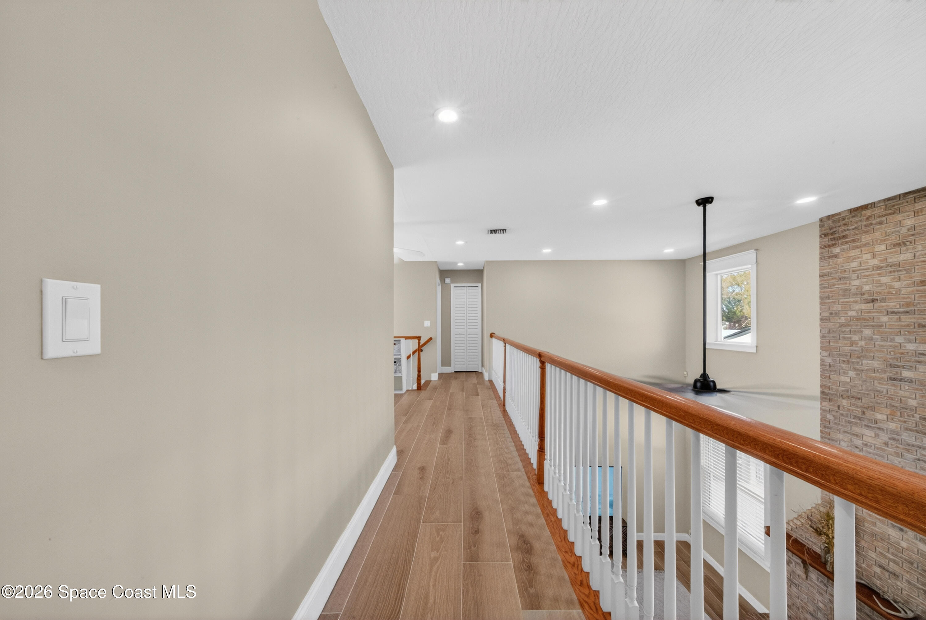 210 Grant Road Merritt Island, FL 32953 - Photo 40 of 64 a view of a hallway with wooden floor and staircase