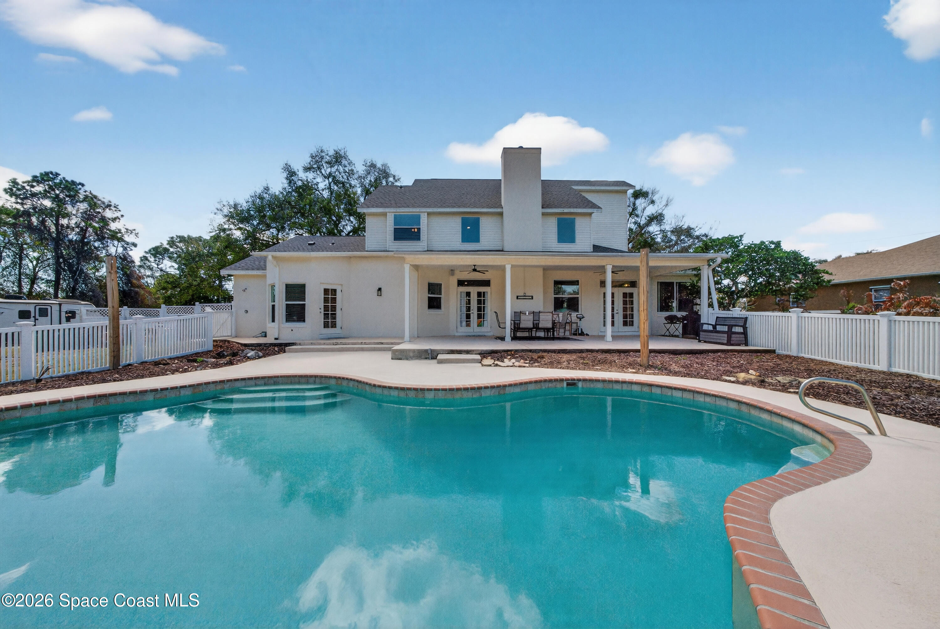210 Grant Road Merritt Island, FL 32953 - Photo 46 of 64 a view of a swimming pool with a lounge chairs