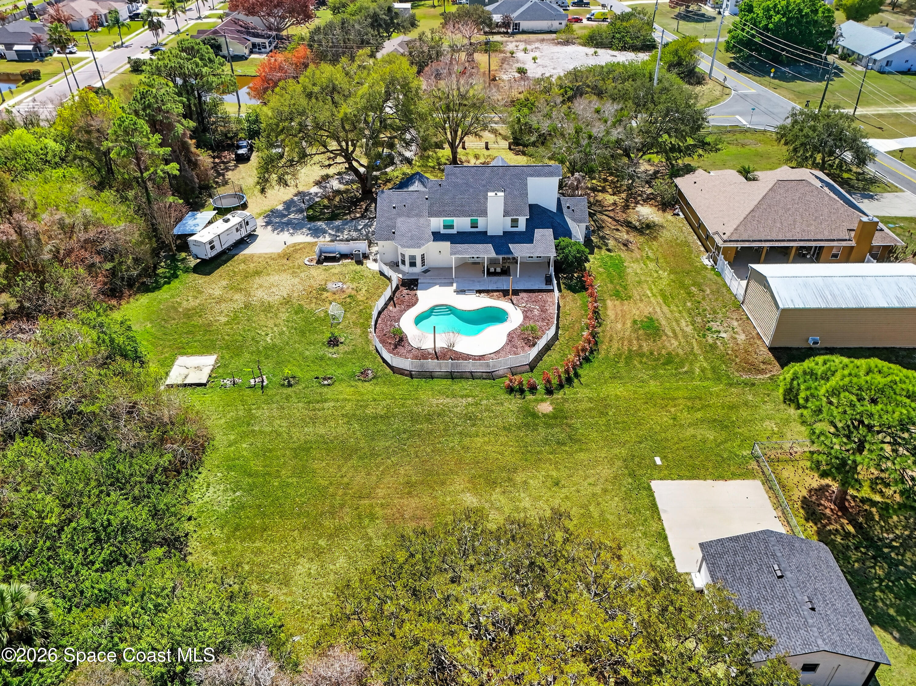210 Grant Road Merritt Island, FL 32953 - Photo 49 of 64 an aerial view of a house with swimming pool outdoor seating and yard
