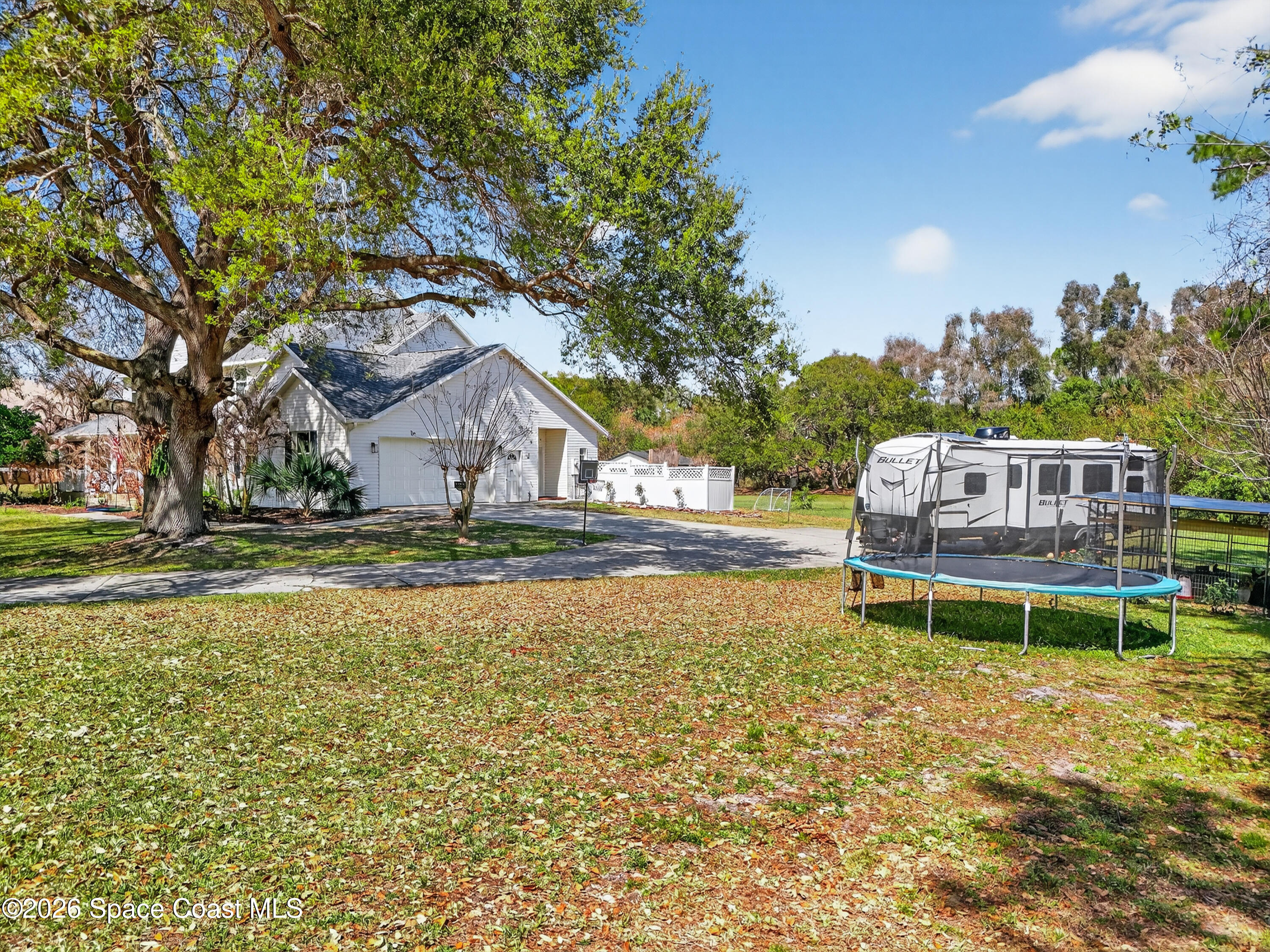 210 Grant Road Merritt Island, FL 32953 - Photo 56 of 64 a backyard of a house with table and chairs