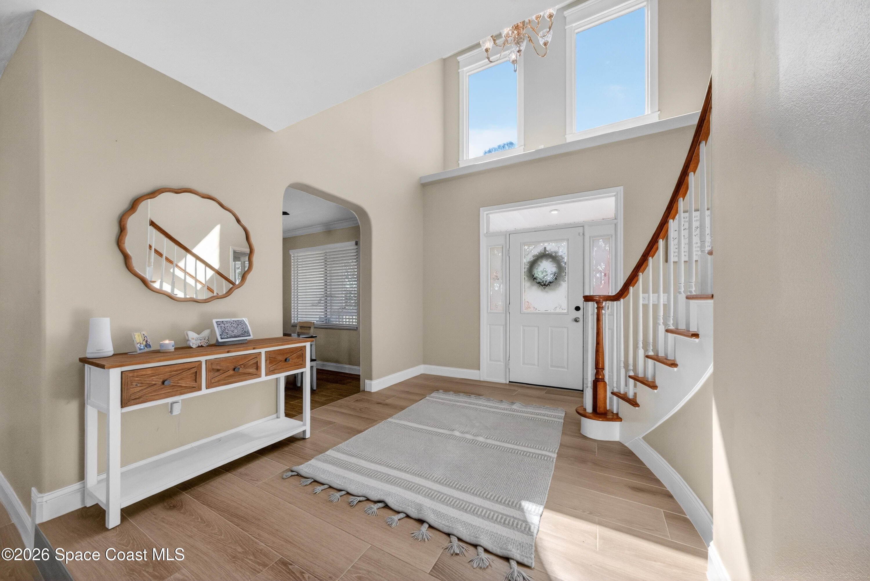 210 Grant Road Merritt Island, FL 32953 - Photo 6 of 64 a view of a livingroom with furniture a fireplace wooden floor and staircase