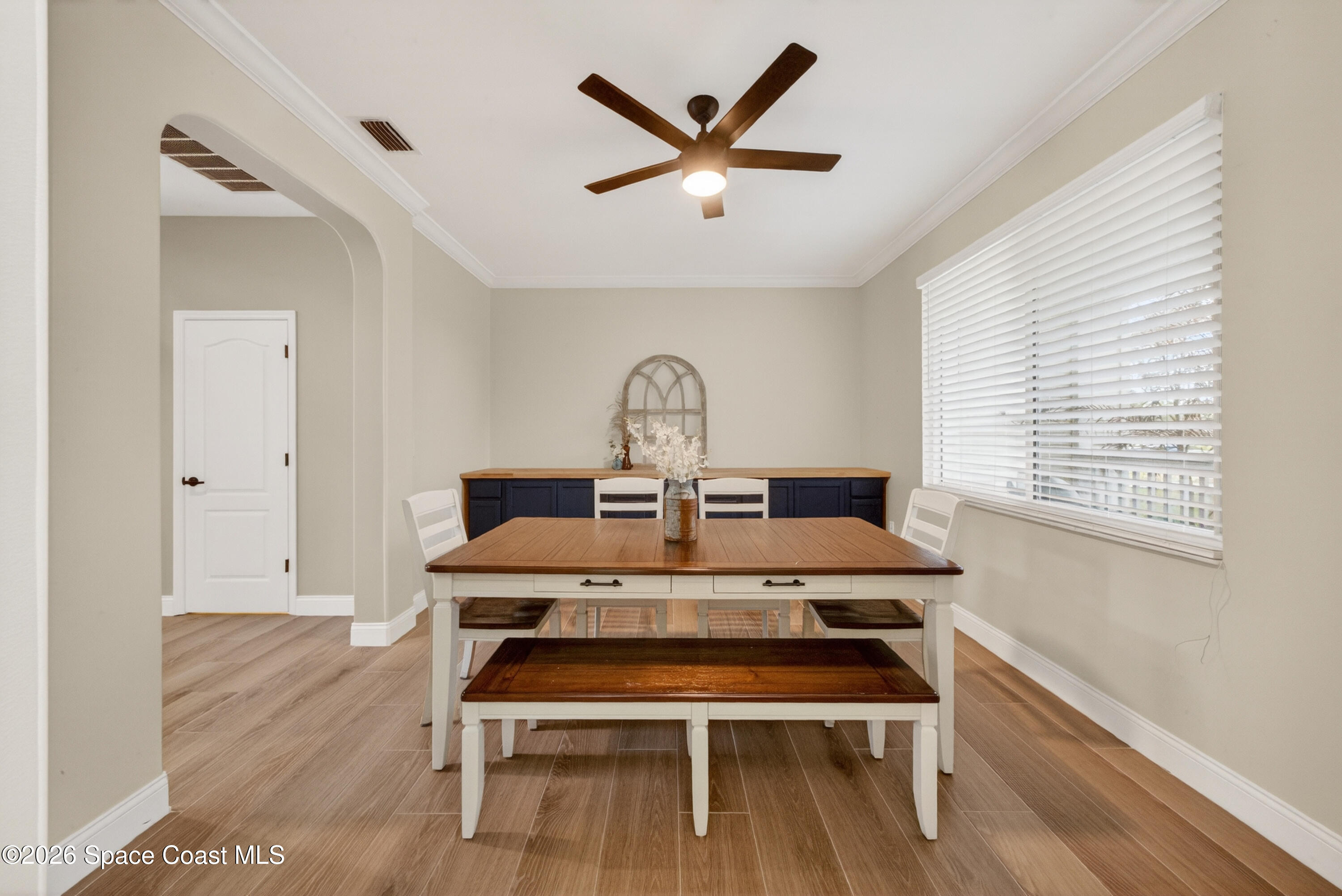 210 Grant Road Merritt Island, FL 32953 - Photo 7 of 64 a view of a workspace with furniture and wooden floor