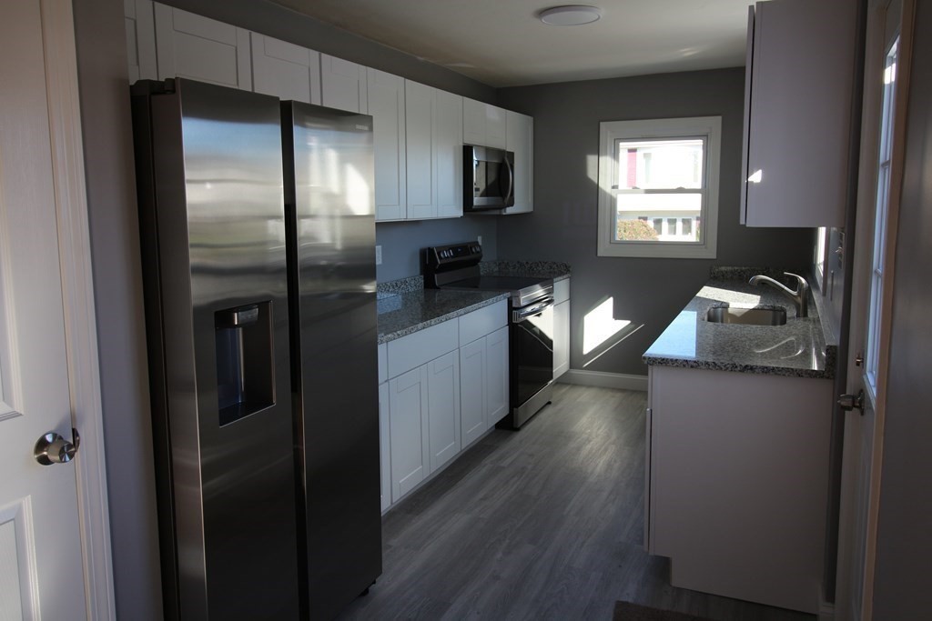 6 Aberdeen Street Fall River, MA 02721 - Photo 5 of 30 a kitchen with a refrigerator and a sink