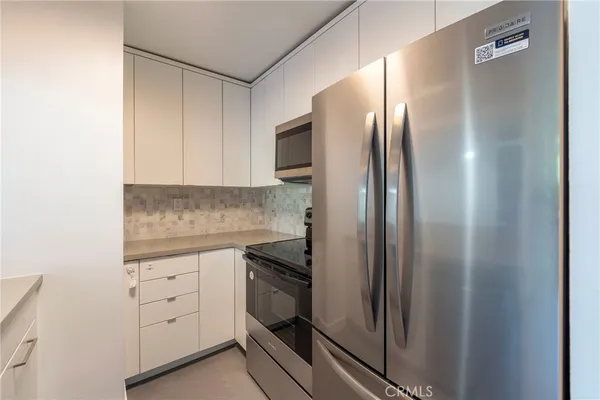 a kitchen with cabinets and stainless steel appliances