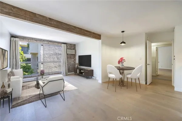 a view of a livingroom with furniture and a window