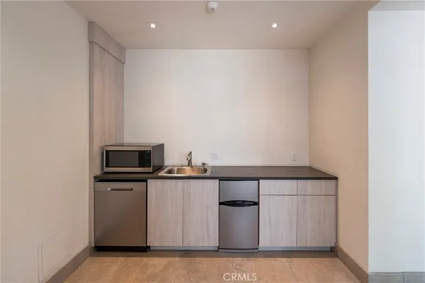 a view of kitchen with microwave and cabinets