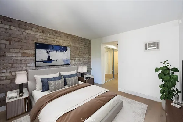 a bedroom with bed and a potted plant