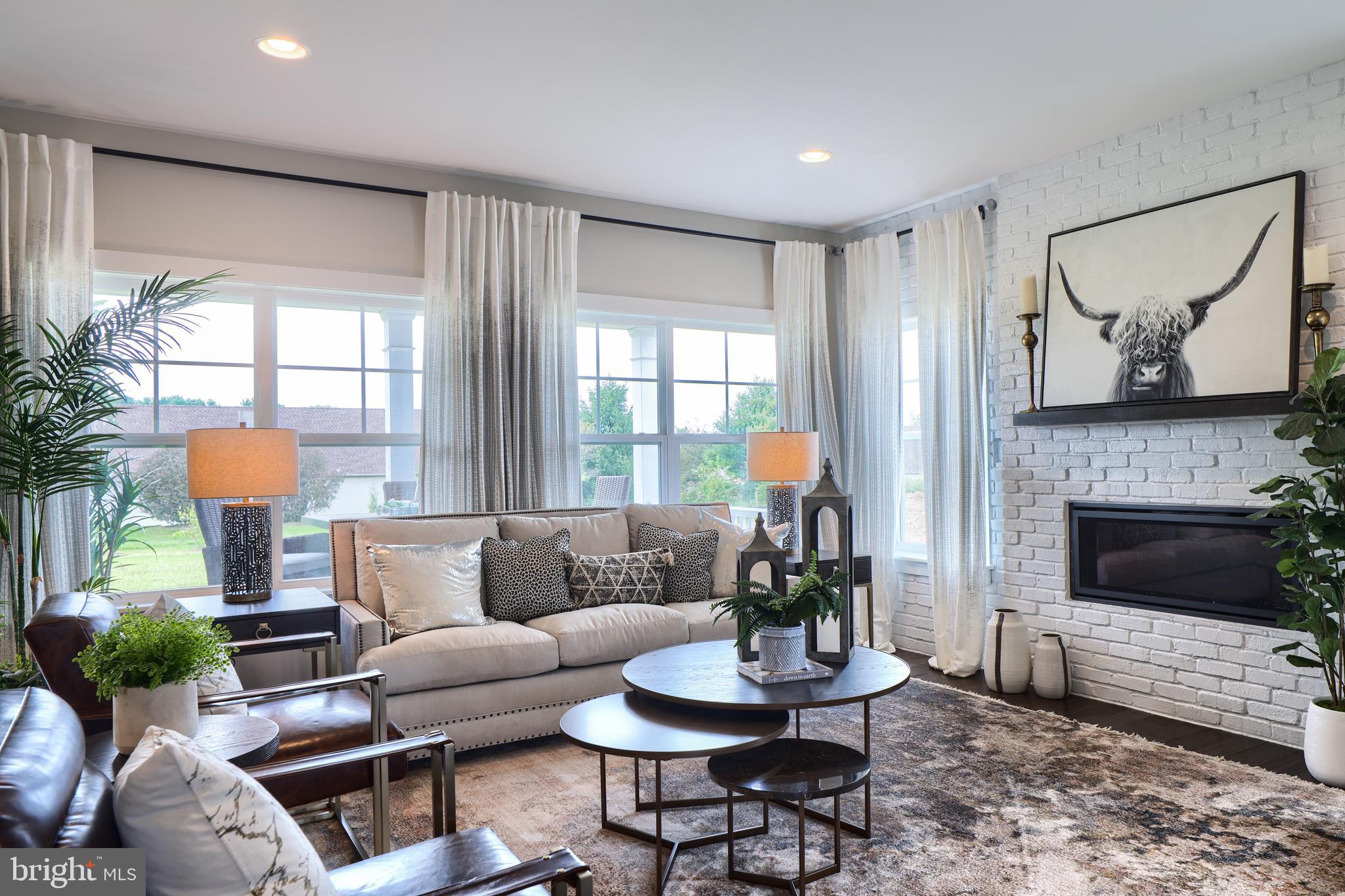 202 Angelica Way New Freedom, PA 17349 - Photo 15 of 48 a living room with furniture a fireplace and a large window