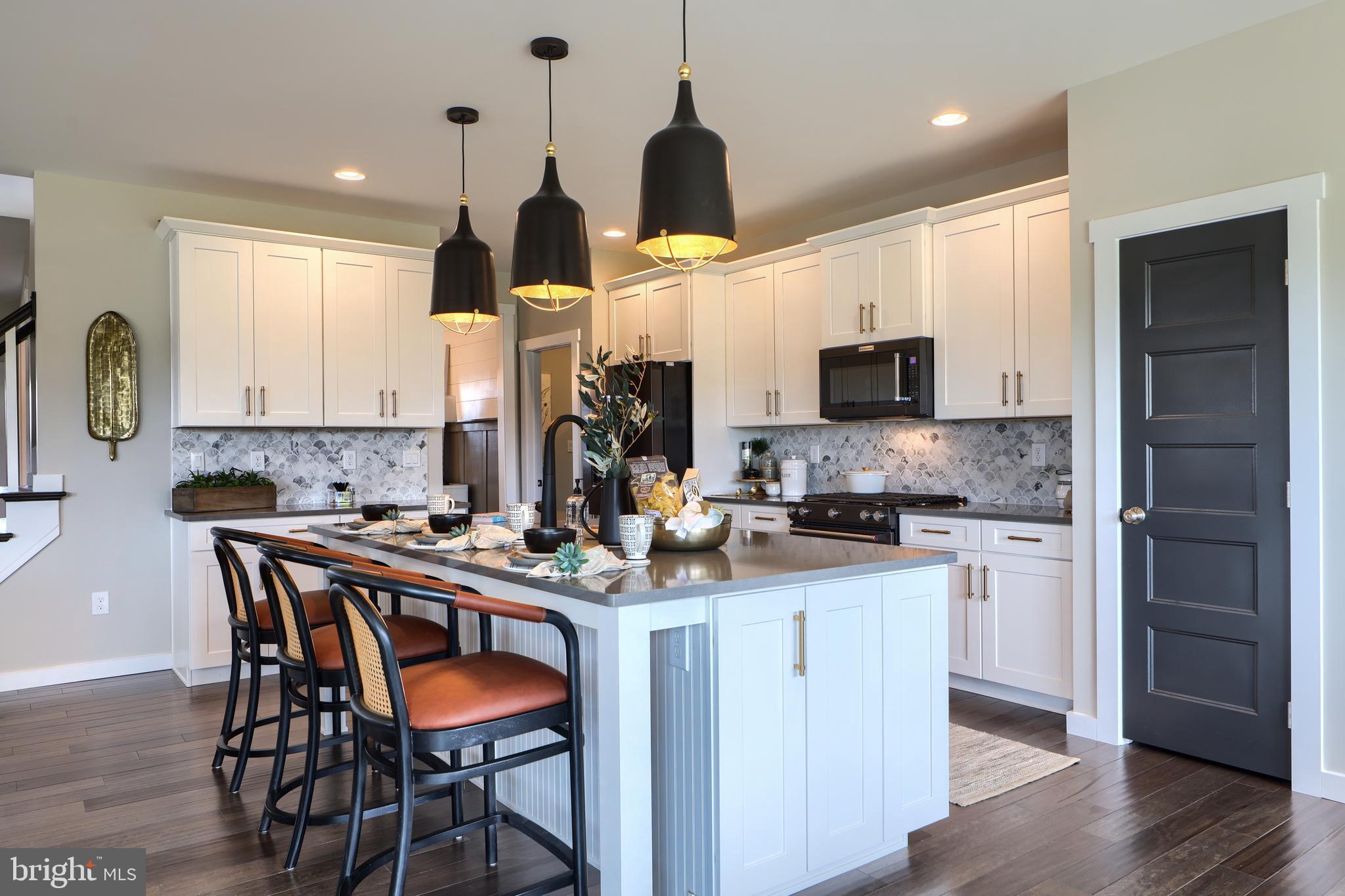 202 Angelica Way New Freedom, PA 17349 - Photo 20 of 48 a kitchen with stainless steel appliances a stove a sink island and a refrigerator