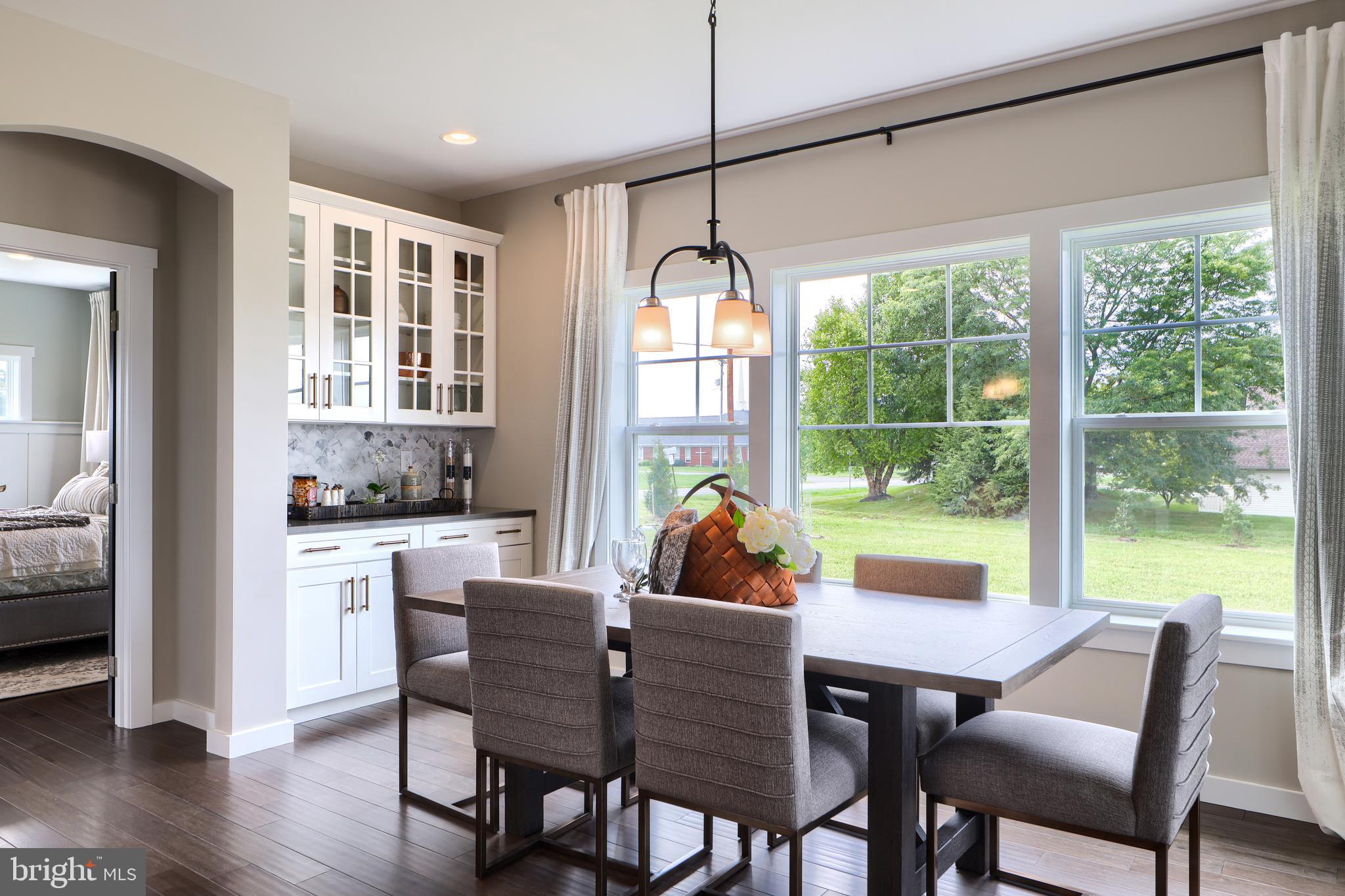 202 Angelica Way New Freedom, PA 17349 - Photo 23 of 48 a view of a dining room with furniture window and wooden floor