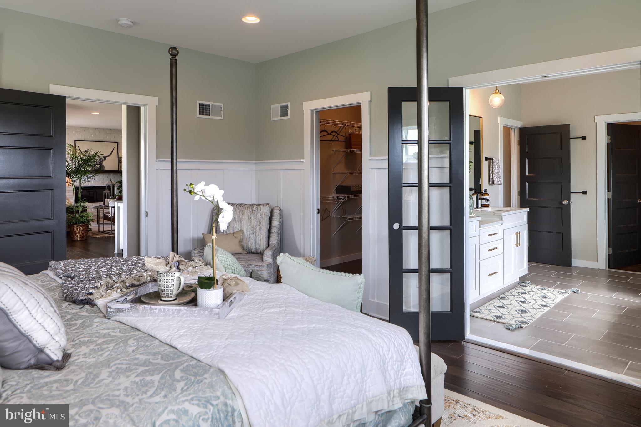 202 Angelica Way New Freedom, PA 17349 - Photo 27 of 48 a bedroom with a large bed and a chandelier