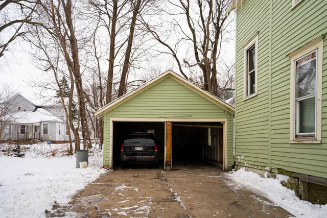 a view of a house with a yard covered in snow