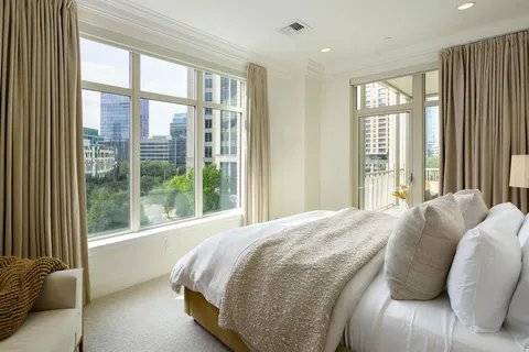 a bed sitting in a bedroom next to a large window