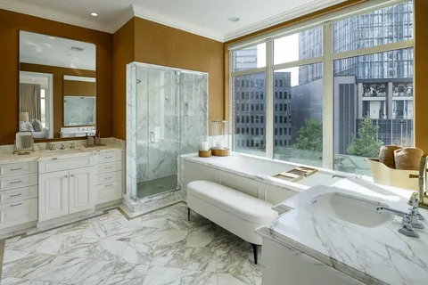 a spacious bathroom with a tub sink and shower