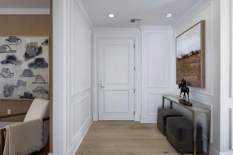 a view of a hallway with a car parked in a kitchen