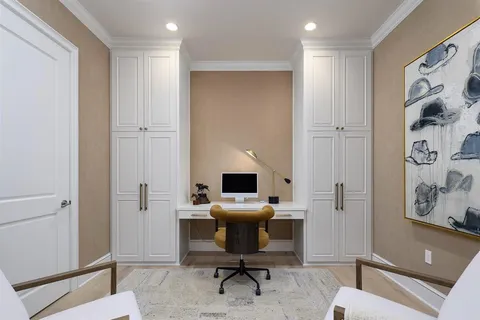 a view of a workspace with furniture and a bathroom