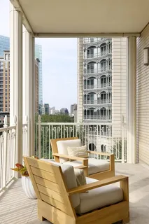 a living room with furniture and a floor to ceiling window