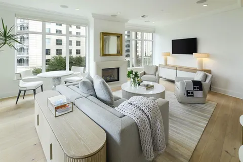 a living room with fireplace furniture and a flat screen tv