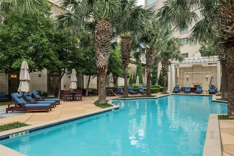 a view of a swimming pool and lounge chairs