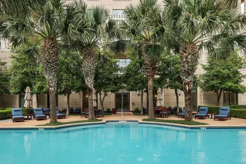 a view of a swimming pool with lounge chairs