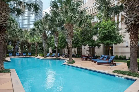 a view of a swimming pool with chairs