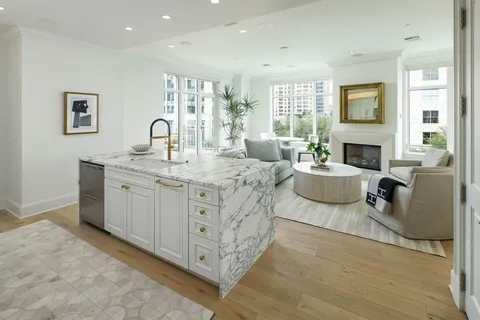 a spacious bedroom with a bed a couch and dresser